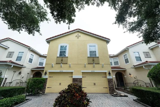 a view of a white house with a yard and plants