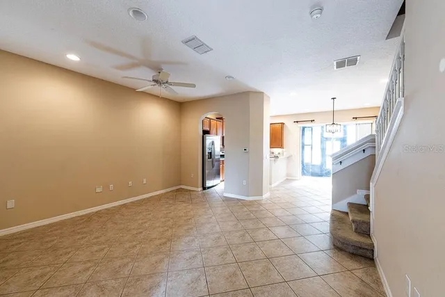 a view of a livingroom with a furniture and chandelier fan