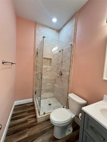 a view of empty room with wooden floor