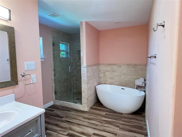 a bathroom with a sink vanity and mirror