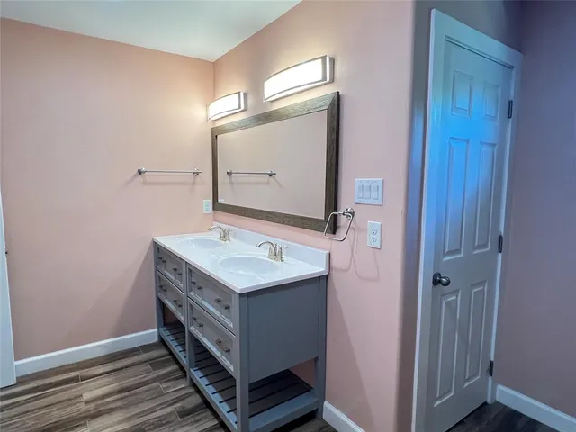 a bathroom with a toilet and a potted plant