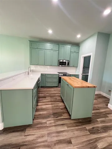 a room with wooden floors and bathtub
