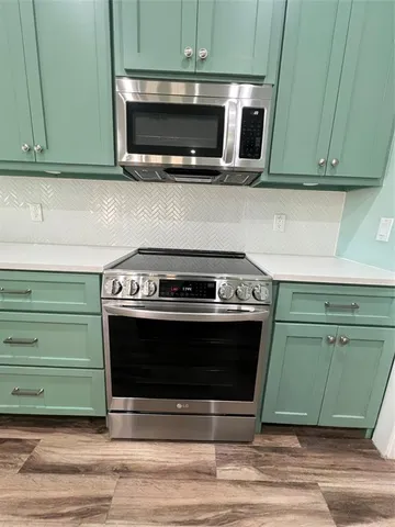 a stove top oven sitting inside of a kitchen