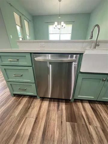 a room with a sink and wooden floor