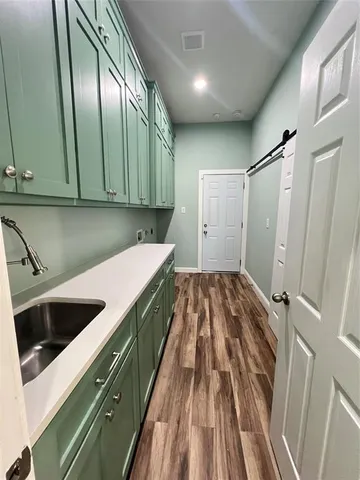 a kitchen with a sink and a refrigerator