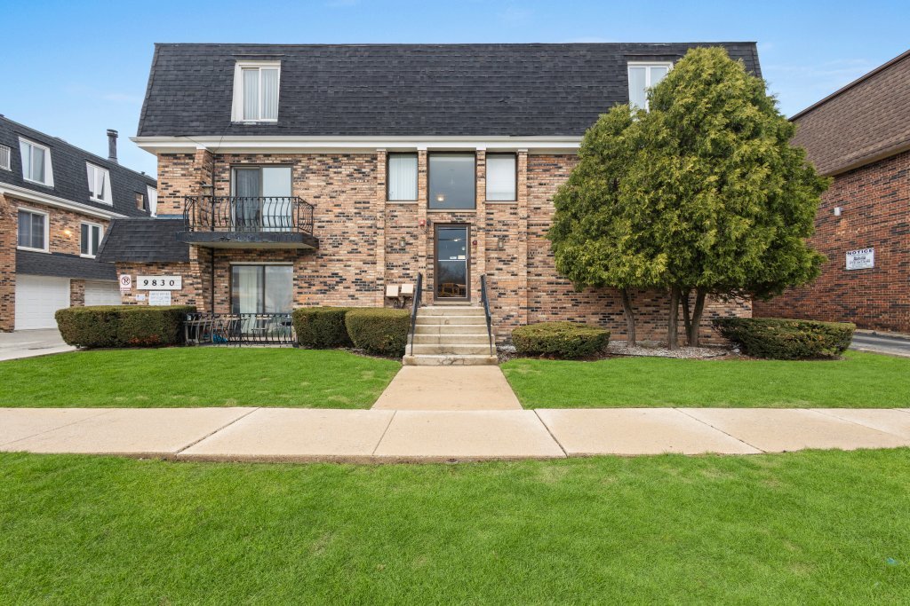 9830 Sayre Avenue, Unit 6 Chicago Ridge, IL 60415 - Photo 1 of 25 a front view of a house with a garden and yard
