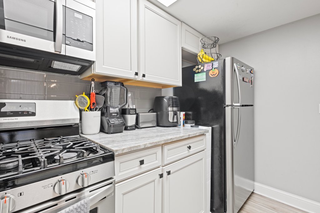 9830 Sayre Avenue, Unit 6 Chicago Ridge, IL 60415 - Photo 11 of 25 a kitchen with stainless steel appliances granite countertop a stove and a refrigerator