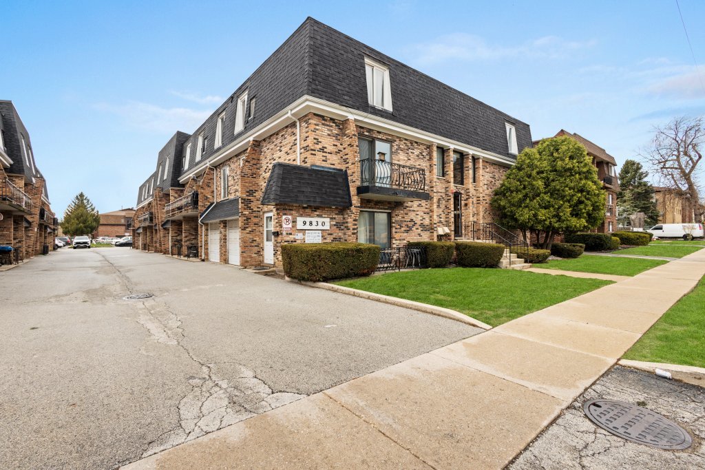 9830 Sayre Avenue, Unit 6 Chicago Ridge, IL 60415 - Photo 2 of 25 a front view of a building with a yard