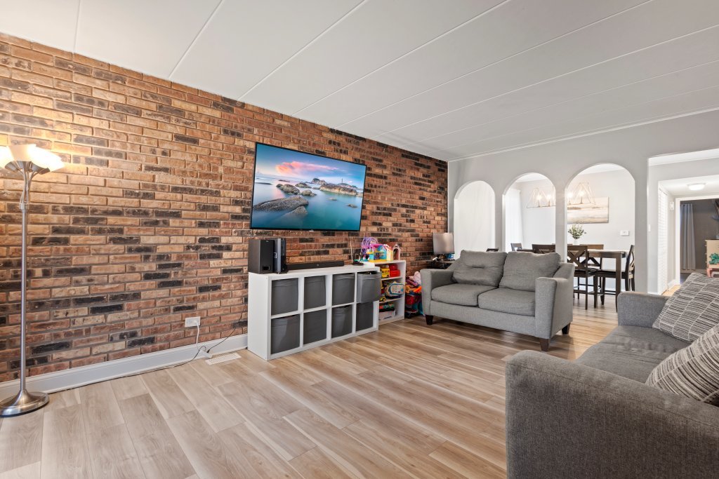 9830 Sayre Avenue, Unit 6 Chicago Ridge, IL 60415 - Photo 5 of 25 a living room with furniture and a flat screen tv