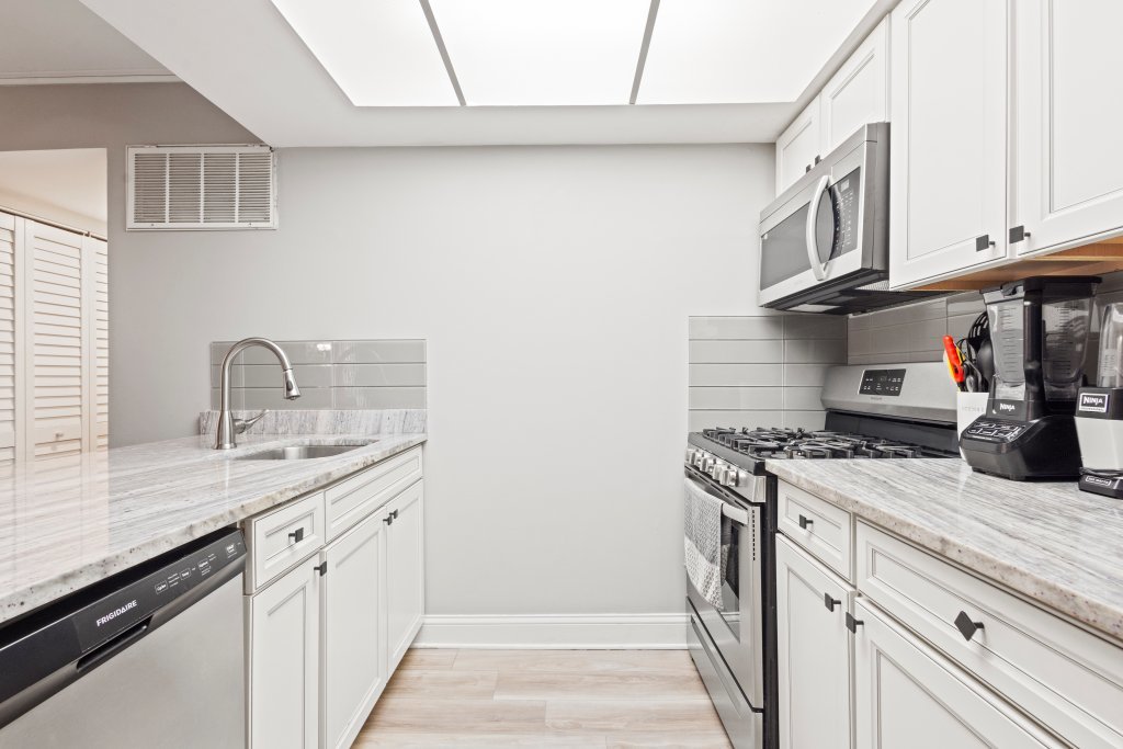 9830 Sayre Avenue, Unit 6 Chicago Ridge, IL 60415 - Photo 9 of 25 a kitchen with stainless steel appliances granite countertop a sink stove and cabinets