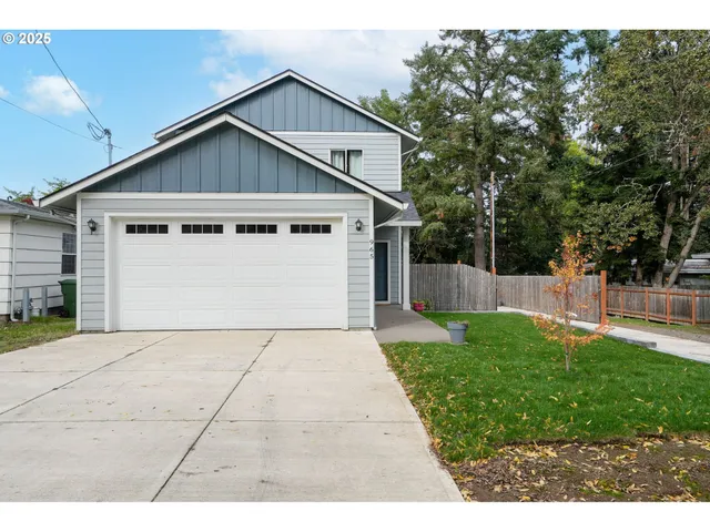 a view of backyard of house with wooden fence