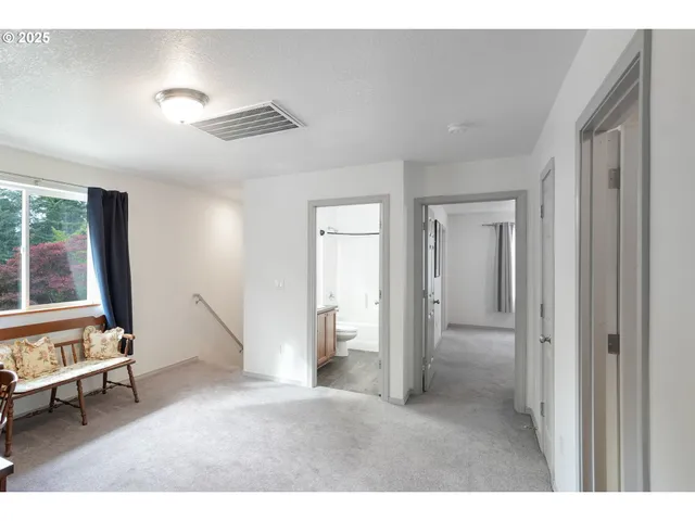 a living room with furniture and large windows