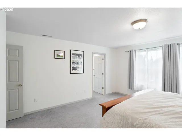 a bedroom with a bed and a lamp