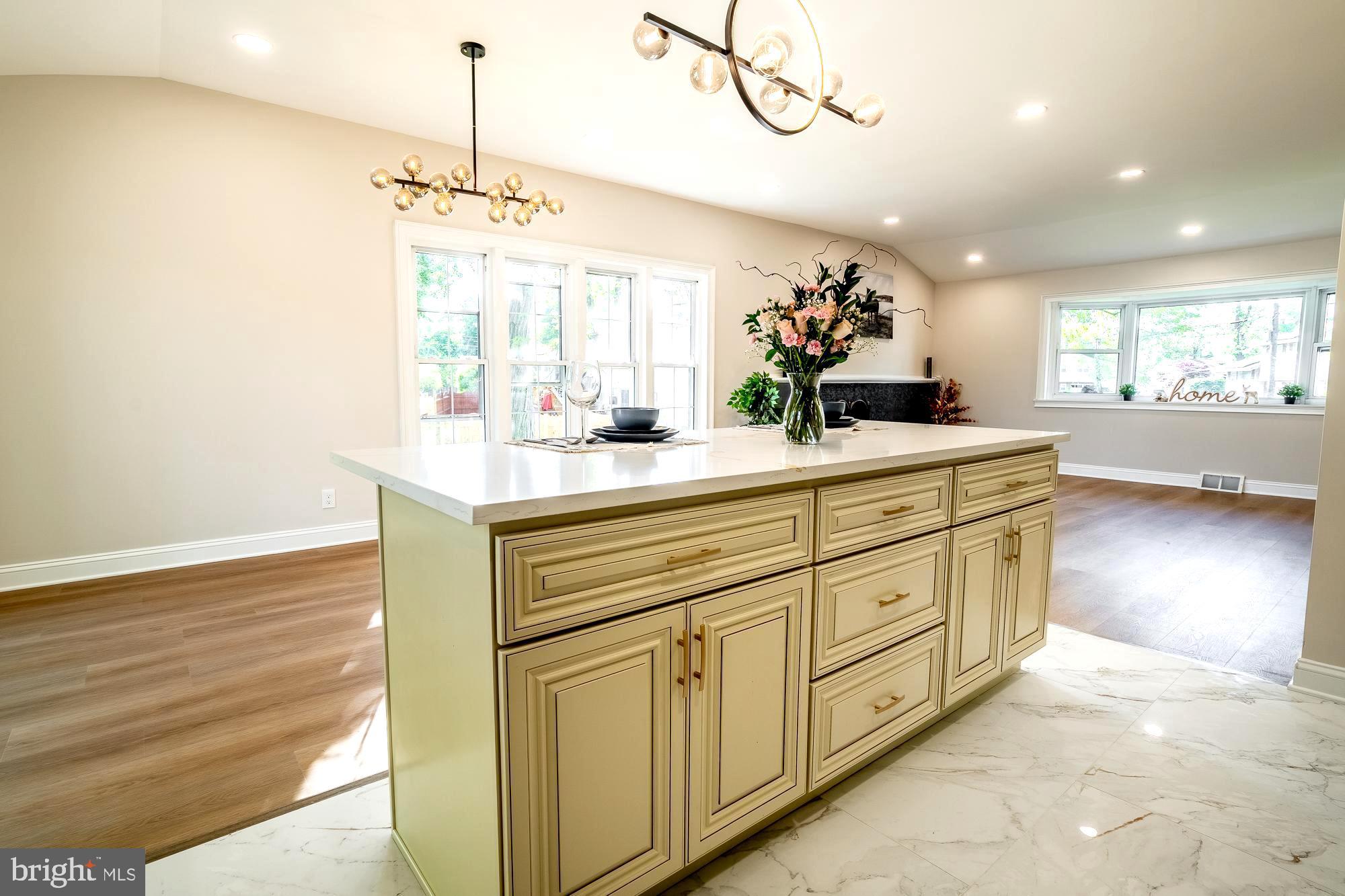 407 Bruce Terrace Cherry Hill, NJ 08034 - Photo 11 of 50 a kitchen with kitchen island granite countertop a sink cabinets and wooden floor