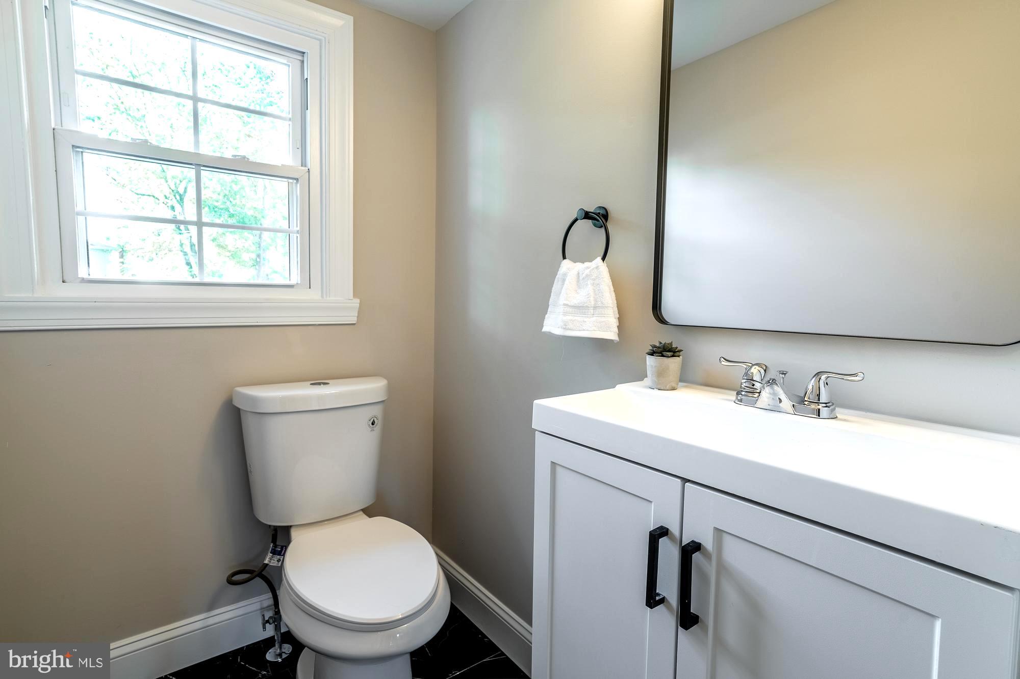 407 Bruce Terrace Cherry Hill, NJ 08034 - Photo 15 of 50 a bathroom with a toilet sink and mirror