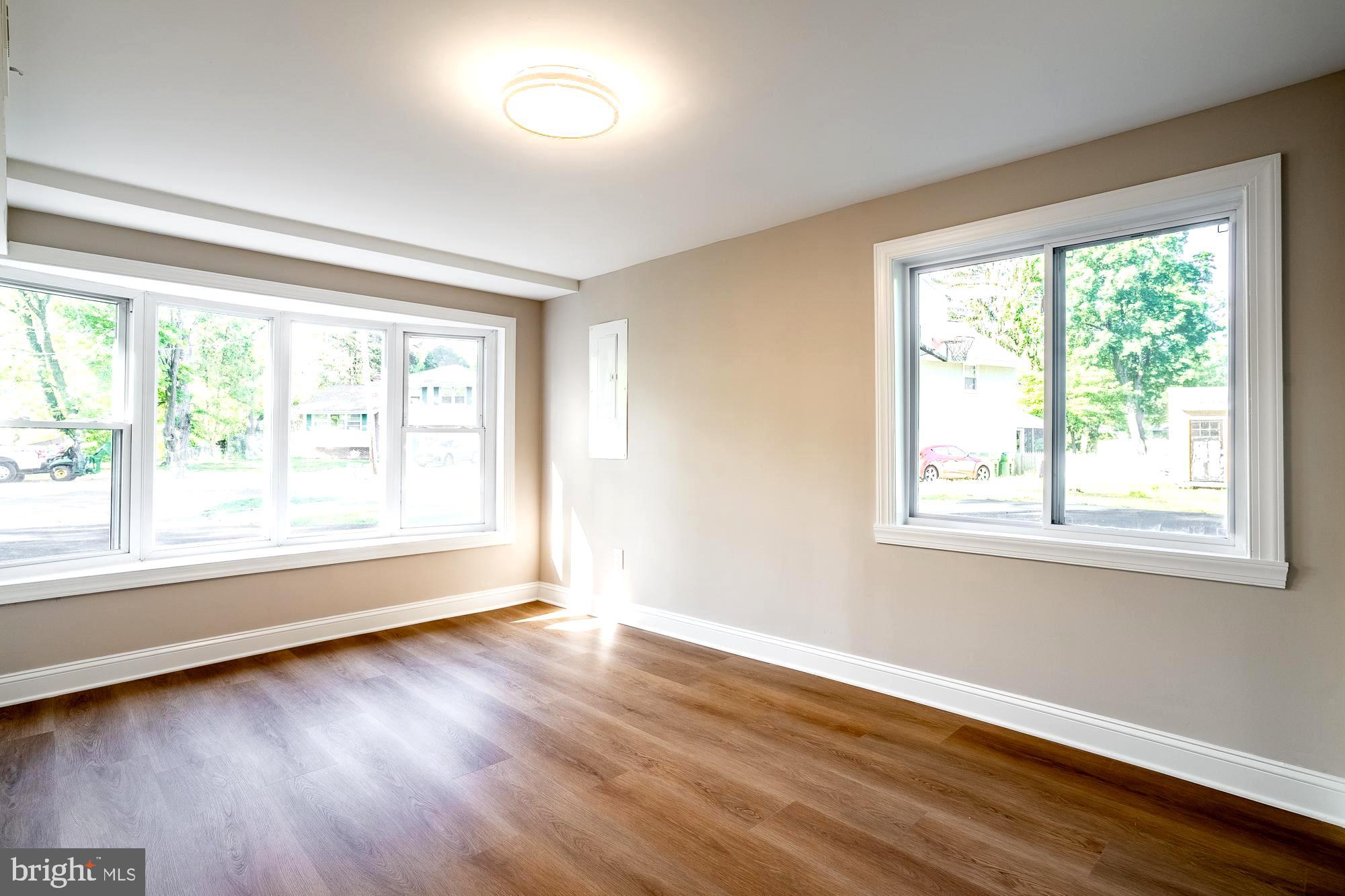 407 Bruce Terrace Cherry Hill, NJ 08034 - Photo 18 of 50 a view of an empty room with wooden floor and a window
