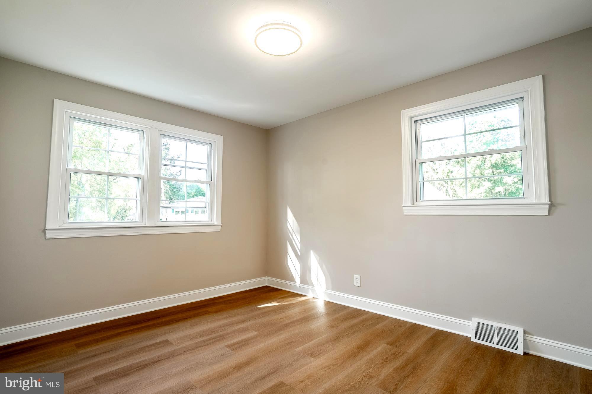 407 Bruce Terrace Cherry Hill, NJ 08034 - Photo 25 of 50 a view of an empty room with wooden floor and a window