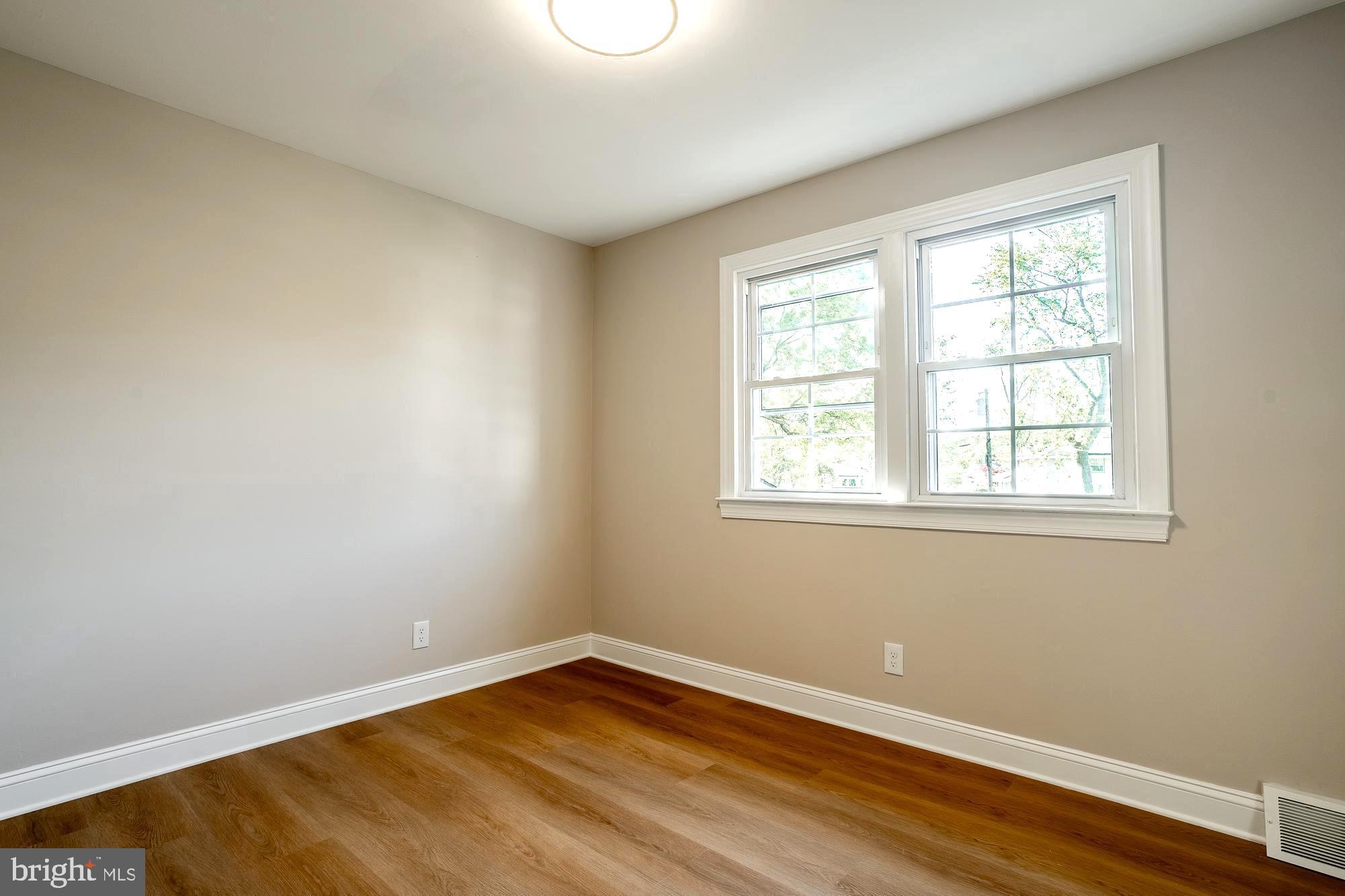 407 Bruce Terrace Cherry Hill, NJ 08034 - Photo 26 of 50 a view of an empty room with wooden floor and a window