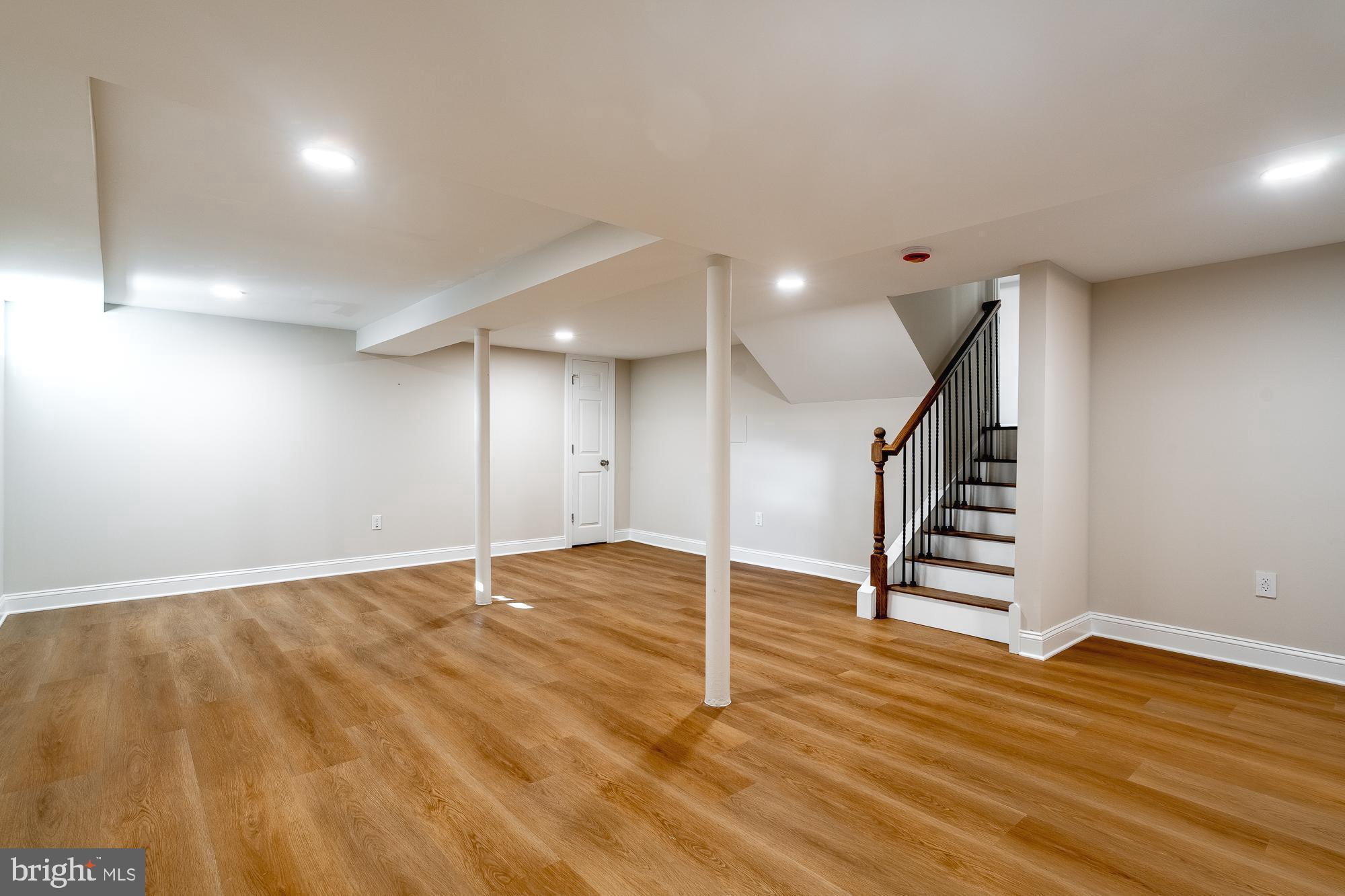 407 Bruce Terrace Cherry Hill, NJ 08034 - Photo 27 of 50 a view of an empty room with wooden floor and stairs