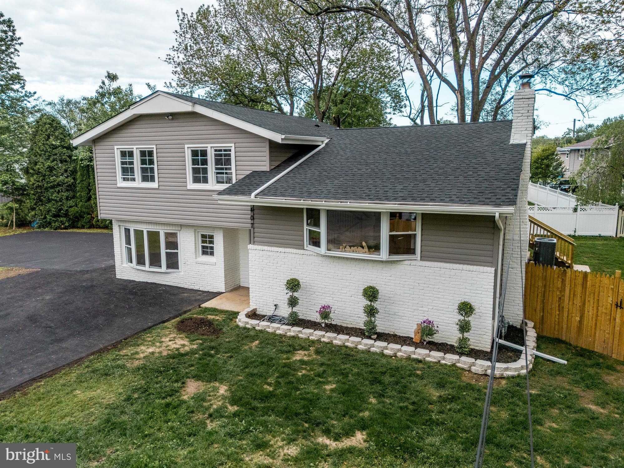 407 Bruce Terrace Cherry Hill, NJ 08034 - Photo 37 of 50 a view of a yard in front of a house with plants and large tree