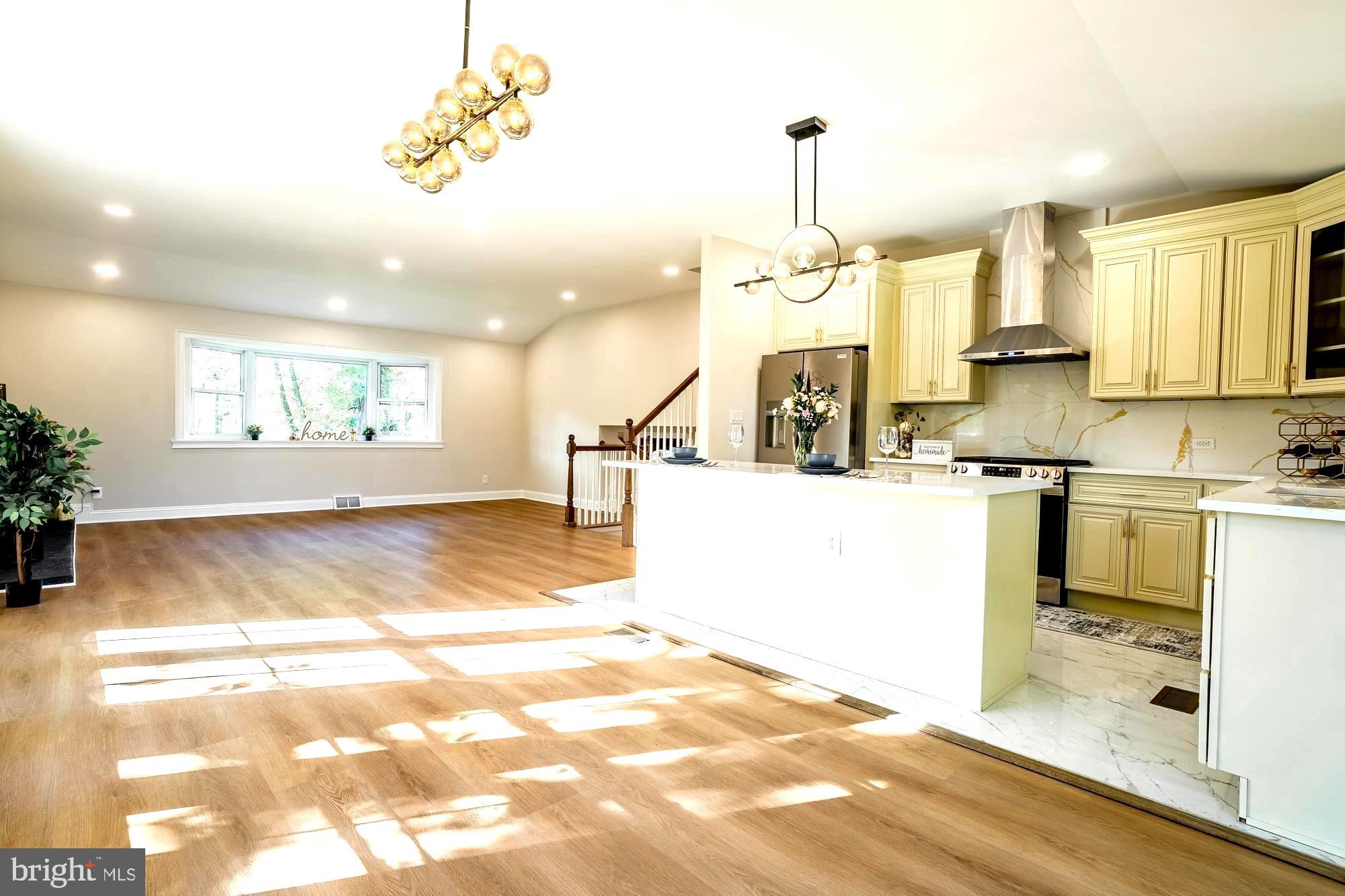 407 Bruce Terrace Cherry Hill, NJ 08034 - Photo 5 of 50 a view of a kitchen with kitchen island a sink a counter top space appliances and cabinets