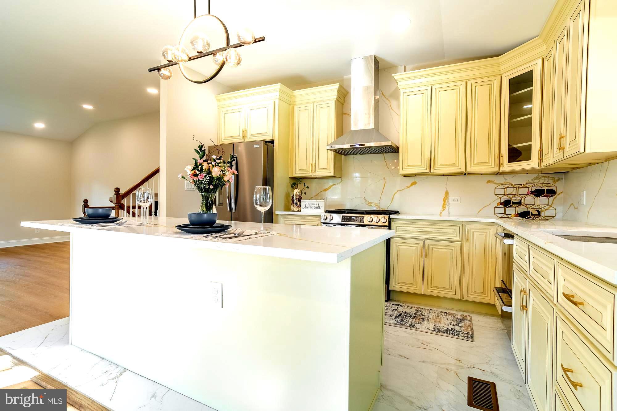 407 Bruce Terrace Cherry Hill, NJ 08034 - Photo 7 of 50 a kitchen with a sink appliances cabinets and a large window