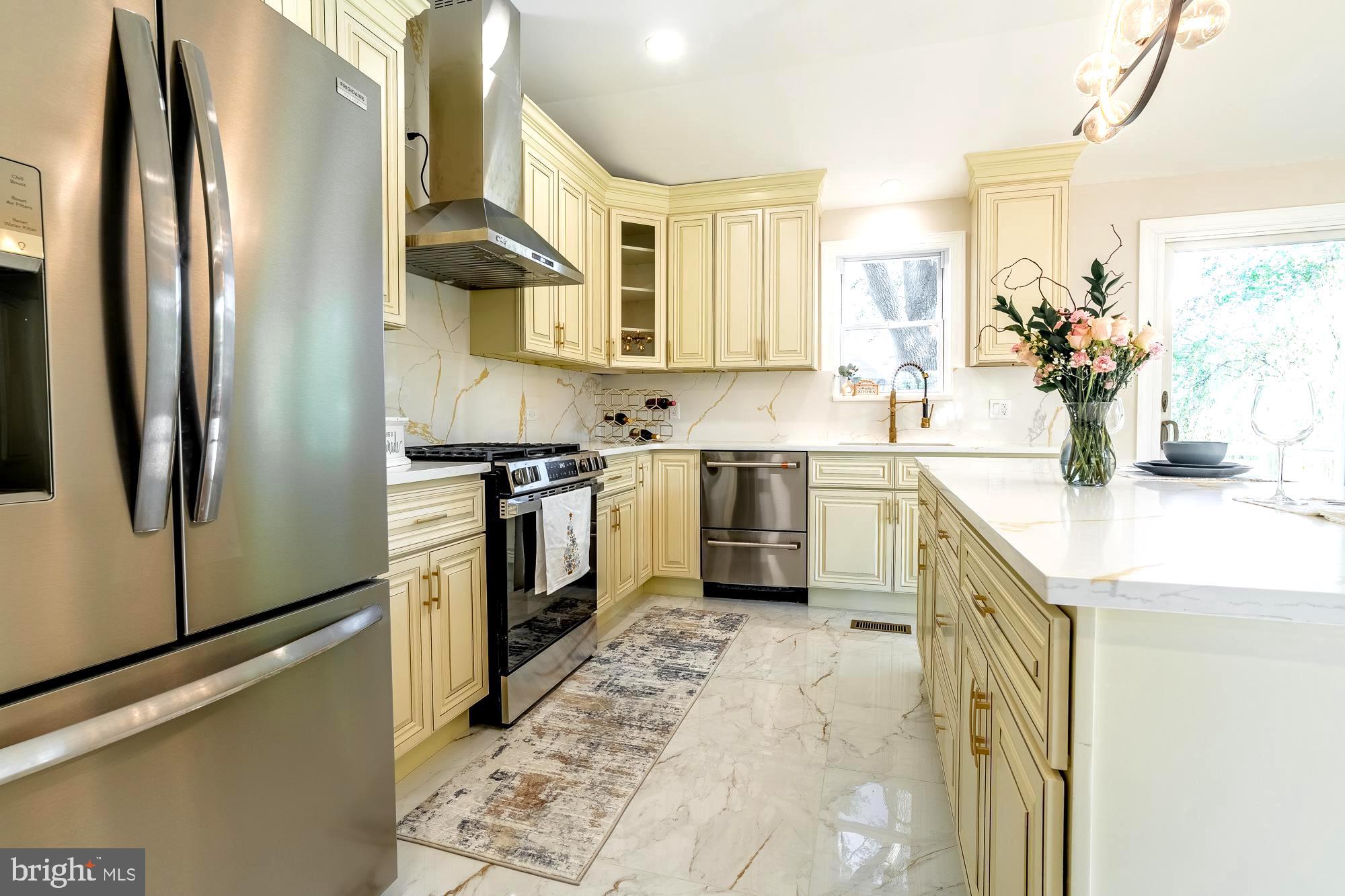 407 Bruce Terrace Cherry Hill, NJ 08034 - Photo 8 of 50 a kitchen with stainless steel appliances granite countertop a sink a stove a refrigerator and a refrigerator