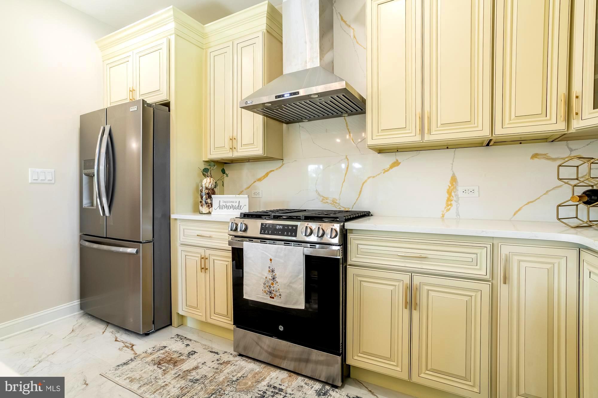 407 Bruce Terrace Cherry Hill, NJ 08034 - Photo 9 of 50 a kitchen with stainless steel appliances granite countertop a refrigerator a stove and a sink