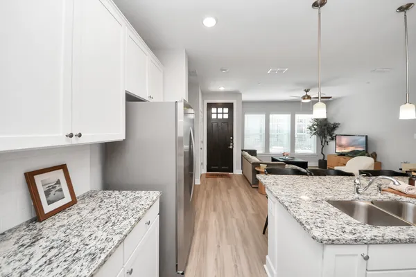 a kitchen with sink refrigerator and stove