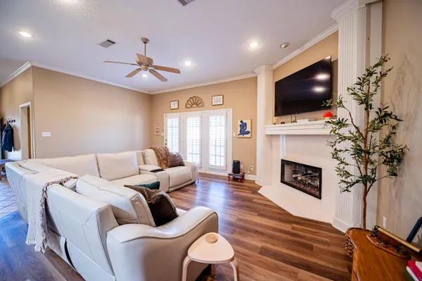 a living room with furniture a fireplace and a flat screen tv