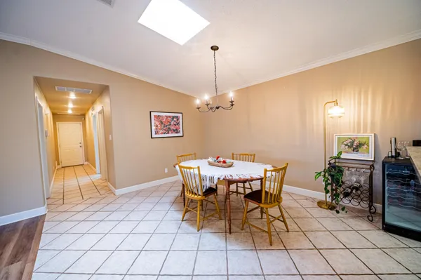 a dining room with furniture and chandelier fan