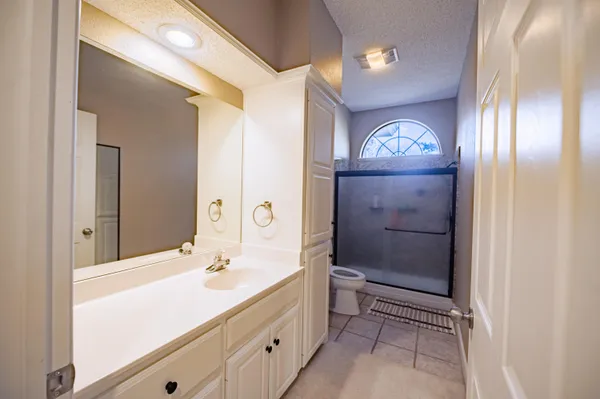 a bathroom with a sink a mirror and a shower