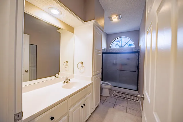 a bathroom with a sink a mirror and a shower