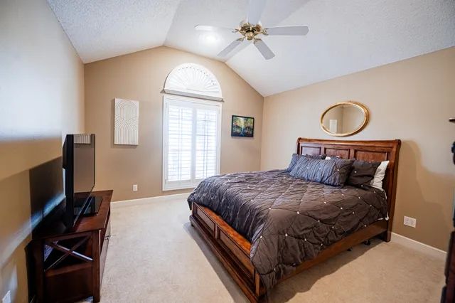 a bedroom with a bed and a chandelier