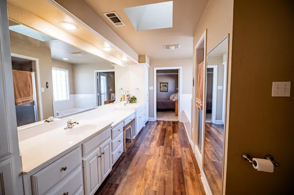 a spacious bathroom with a double vanity sink and a mirror