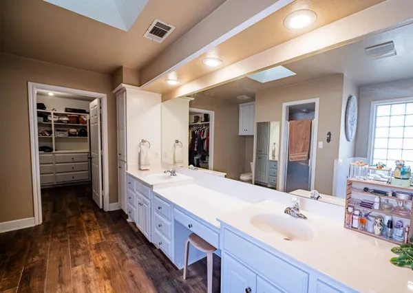 a bathroom with a double vanity sink and a mirror