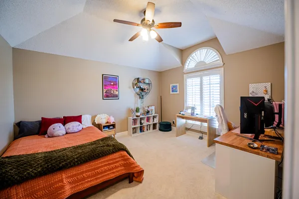a bedroom with furniture and a window