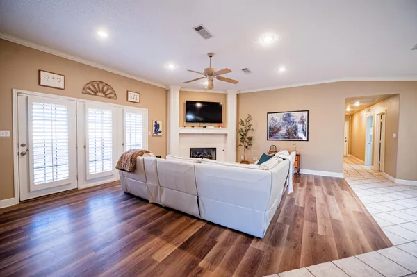 a living room with furniture fireplace and wooden floor