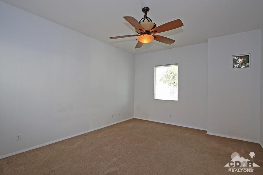 49478 Lewis Road Indio, CA 92201 - Photo 2 of 34 an empty room with a window and a fan