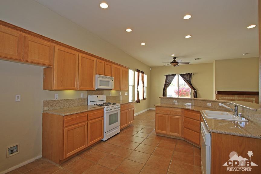 49478 Lewis Road Indio, CA 92201 - Photo 12 of 34 a kitchen with a sink stove and cabinets