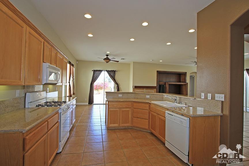 49478 Lewis Road Indio, CA 92201 - Photo 13 of 34 a large kitchen with stainless steel appliances lots of counter space and a sink