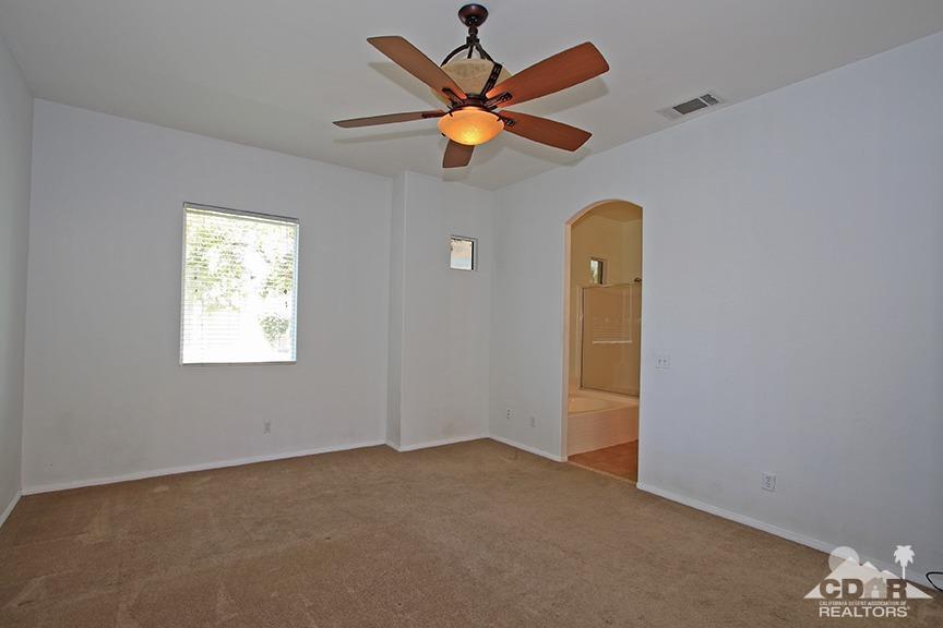 49478 Lewis Road Indio, CA 92201 - Photo 15 of 34 an empty room with windows and fan