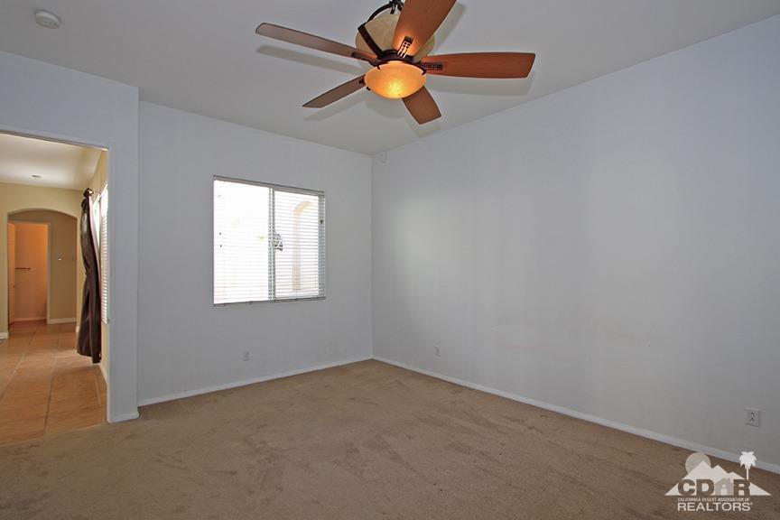 49478 Lewis Road Indio, CA 92201 - Photo 17 of 34 an empty room with windows and fan