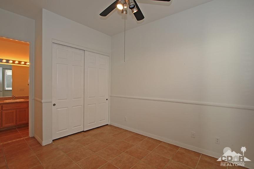 49478 Lewis Road Indio, CA 92201 - Photo 25 of 34 an empty room with a ceiling fan and carpet