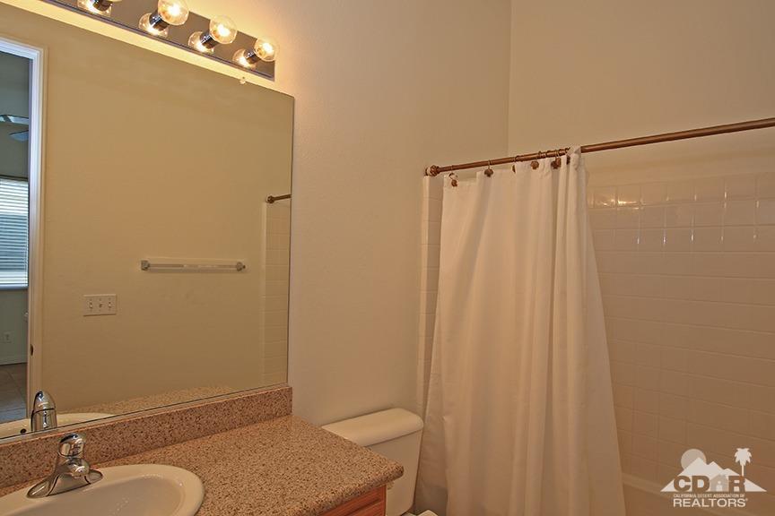 49478 Lewis Road Indio, CA 92201 - Photo 27 of 34 a bathroom with a shower curtain and a sink