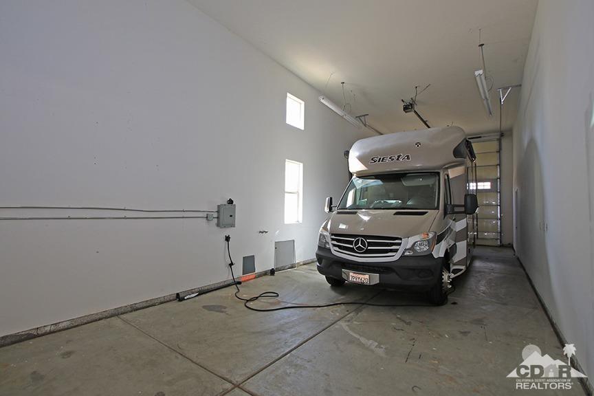 49478 Lewis Road Indio, CA 92201 - Photo 33 of 34 a bedroom with furniture and a chandelier