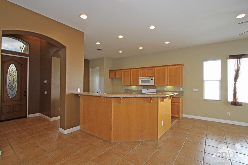 49478 Lewis Road Indio, CA 92201 - Photo 8 of 34 a kitchen with stainless steel appliances granite countertop a refrigerator and a sink
