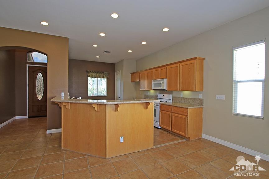 49478 Lewis Road Indio, CA 92201 - Photo 9 of 34 a kitchen with stainless steel appliances granite countertop a refrigerator and a stove top oven
