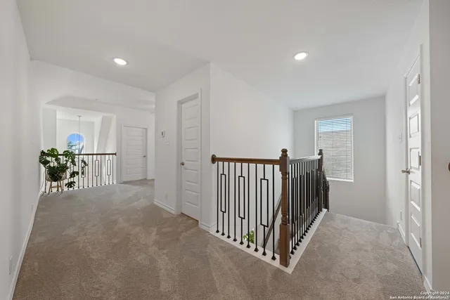 a view of a hallway to a livingroom and a couch
