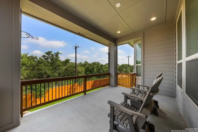 a view of a hallway with chairs and front door
